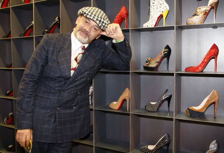 Christian Louboutin con algunos de sus creaciones.