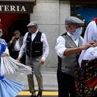 Two couples dressed up in the Madrid traditional "chulapa" and "chulapo" costumes dance to the sound of a barrel organ on May 15, 2021 during the town's local holiday of "San Isidro" that honours Madrid's patron Saint Isidore the Labourer. (Photo by GABRIEL BOUYS / AFP)