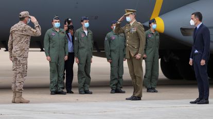 El rey Felipe VI saluda a los soldados recién llegados de Afganistán, en presencia del presidente del Gobierno, Pedro Sánchez (a la derecha), este jueves en la base aérea de Torrejón.
