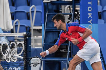 Serbia's Novak Djokovic smashes his racket during his Tokyo 2020 Olympic Games men's singles tennis match for the bronze medal against Spain's Pablo Carreno Busta at the Ariake Tennis Park in Tokyo on July 31, 2021. (Photo by Tiziana FABI / AFP)