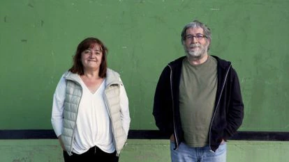 Rita Labiano junto a Jezabel Oroz, de 66 años y cartero de la zona. Ambos tienen hijos y se enrolaron en Bizirik Gaude para que, entre otras cosas, estos no se tuviesen que ir a Pamplona al cumplir los 16 años, un desplazamiento que conlleva un desarraigo temprano y altos gastos económicos para las familias, que tienen que costear una residencia en la ciudad. “Hay que desterrar los mitos: en ningún caso somos héroes”, coinciden. “Aquí vivimos bien, pero luchamos para mejorar las cosas”. Ambos posan en el frontón de Izal, un pueblo de unos 40 habitantes a 20 minutos en coche de Otsagabia.
