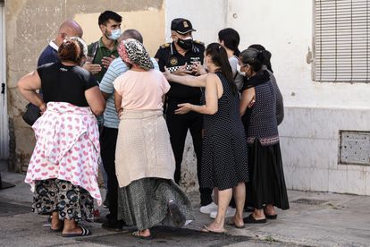 Un policía conversa con los vecinos afectados por el desalojo en Valencia, un miembro del Sindicato Construimos Malilla y un trabajador social. 