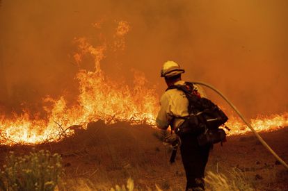 Un bombero combate las llamas del incendio Caldor en la autopista 89.