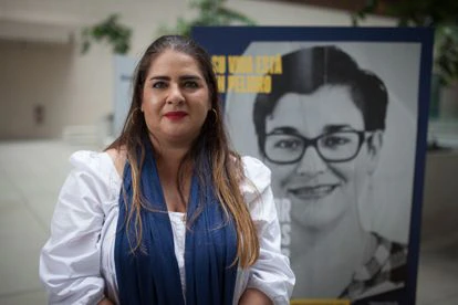 La activista Mariángeles Delgado posa frente a carteles de presos políticos.