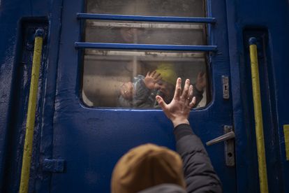 Un hombre se despide de su esposa e hijo, a punto de partir en un tren a Lviv desde la estación de Kiev, el pasado 3 de marzo. 