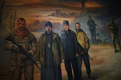El conocido cantante de ópera Vasil Slipak (izquierda), que murió de un disparo en 2016 mientras combatía en Donbás, aparece representado en uno de los frescos del monasterio de San Teodosio de Kiev.