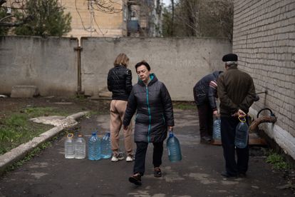 Varios vecinos llenan garrafas de agua en Avdiivka este sábado. 