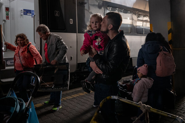 A father reuniting with his daughter in Kyiv after she and her mother returned from Poland on Monday.