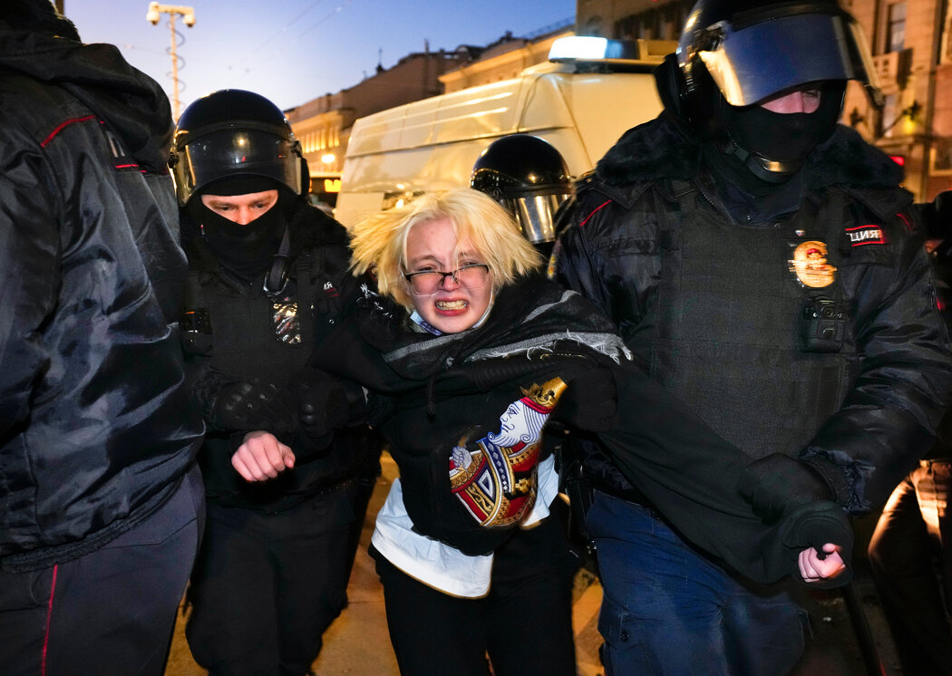 A photo of an antiwar demonstrator being detained by police in St. Petersburg, Russia.