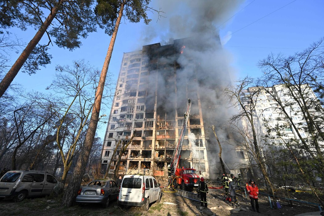 Firefighters work to extinguish a fire in a 16-story residential building in Kyiv.