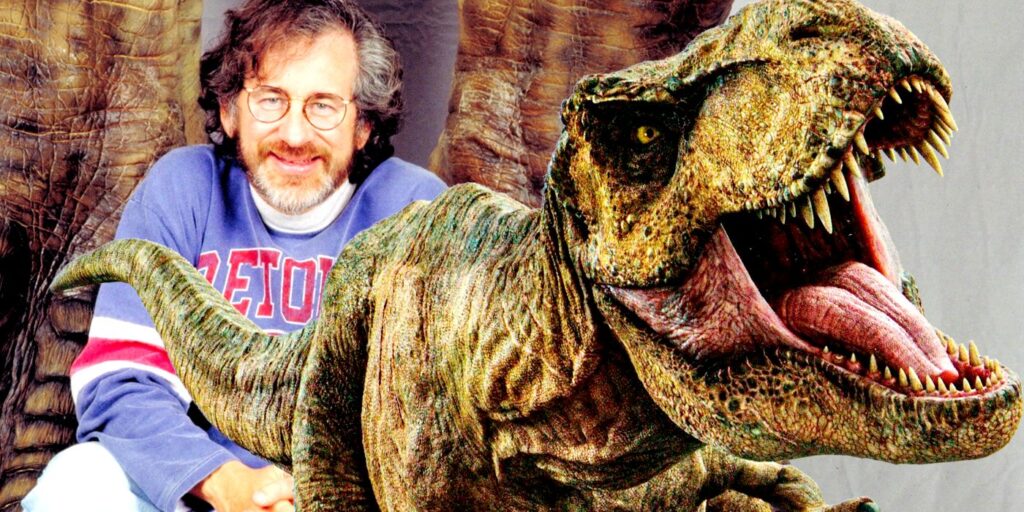 Publicity still of Steven Spielberg stood in front of a T-Rex's legs for Jurassic Park (1993), with a T-Rex from Jurassic World pasted in front to the right.