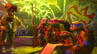 Teenage Mutant Ninja Turtles Mutant Mayhem still featuring April O'Neill standing while the Turtles look at her