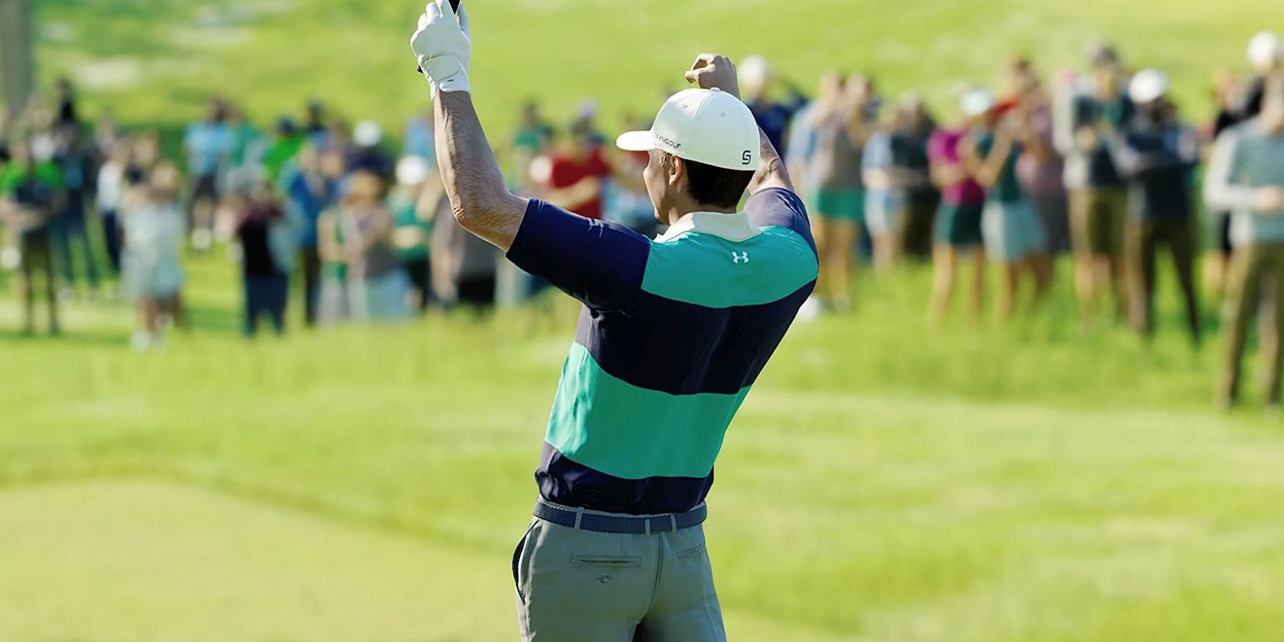 A golfer in EA Sports PGA Tour with their back turned to the camera and their arms up in celebration.