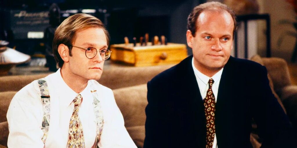 Frasier and Niles sitting on the couch making neutral face in Frasier