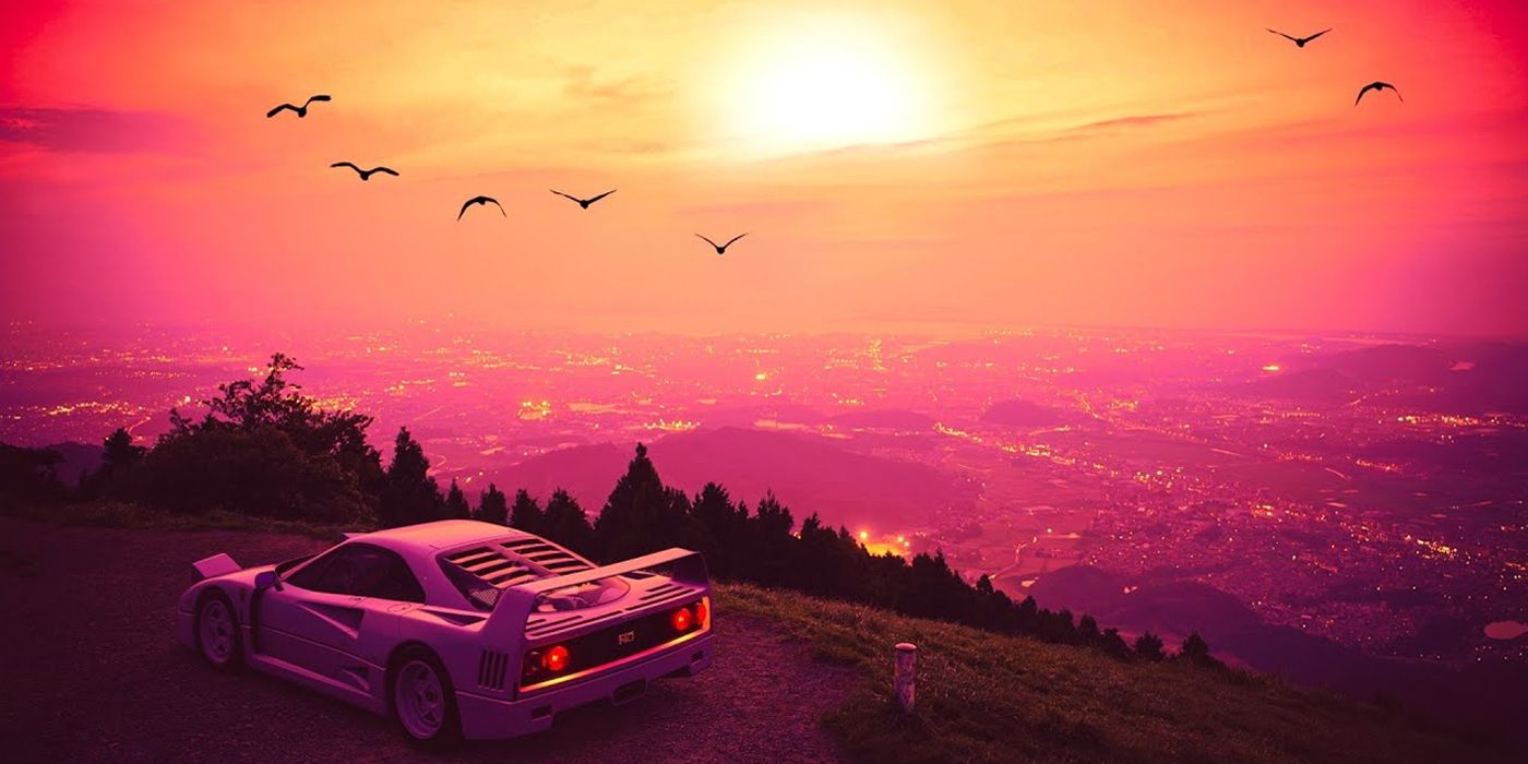 A sports car parked overlooking a massive Vice City map and beyond as the sun sets, creating and orange and pink glow