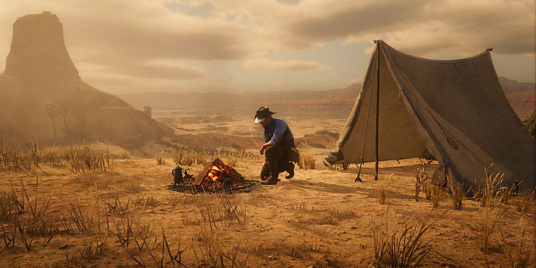 Arthur is kneeling in front of a campfire in his temporary camp atop a plateau in the desert.