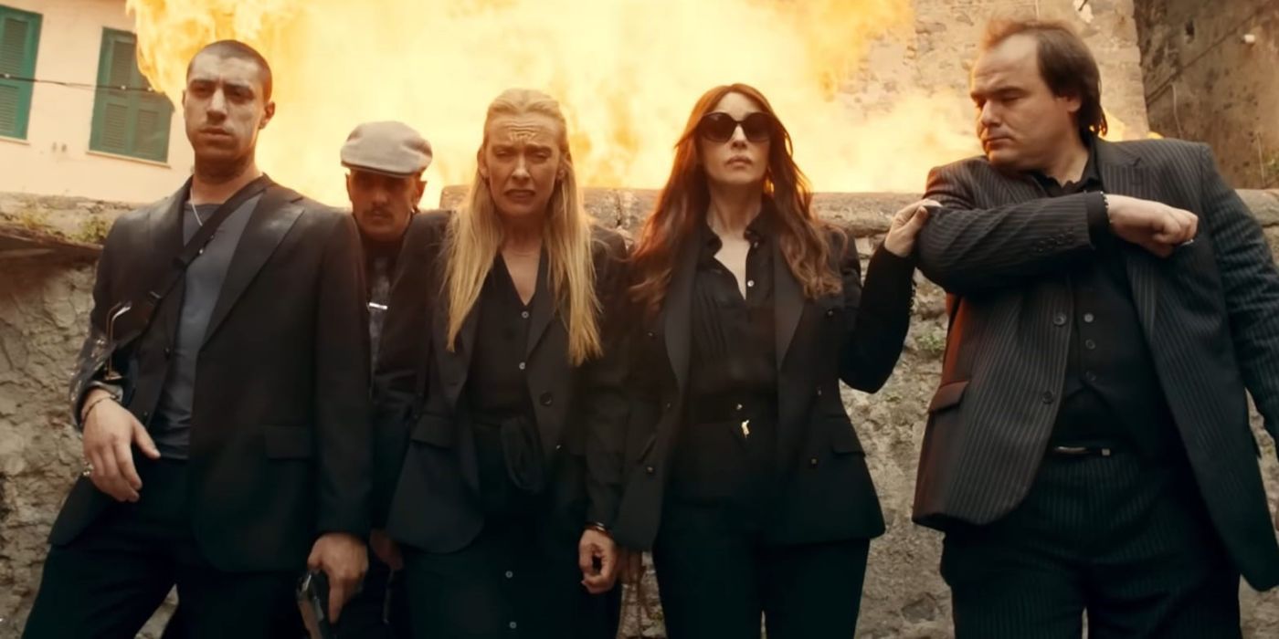 Toni Collette surrounded by mobsters while an explosion happens in the background.