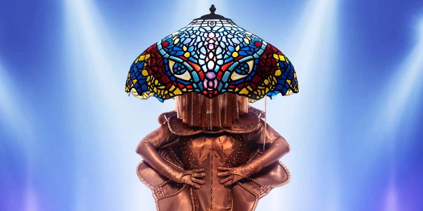 The Masked Singer season 9's Lamp posing agiainst blue background
