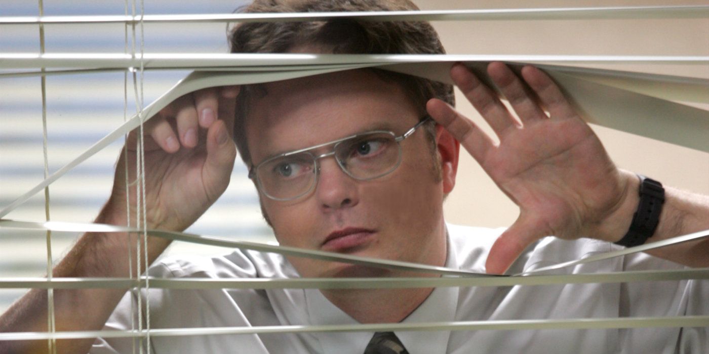 Dwight looking through the blinds on The Office