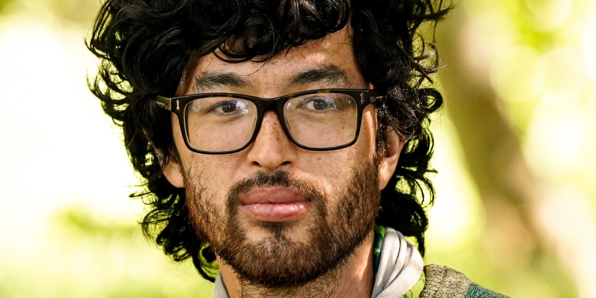 Matt Blankinship Survivor 44 looking serious in glasses yellow background