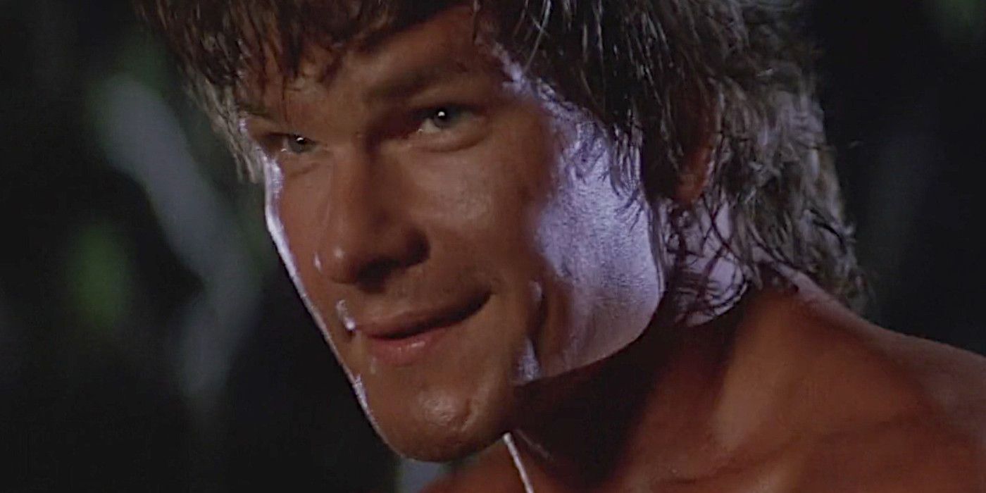 Patrick Swayze in Road House in the middle of a fight, smiling