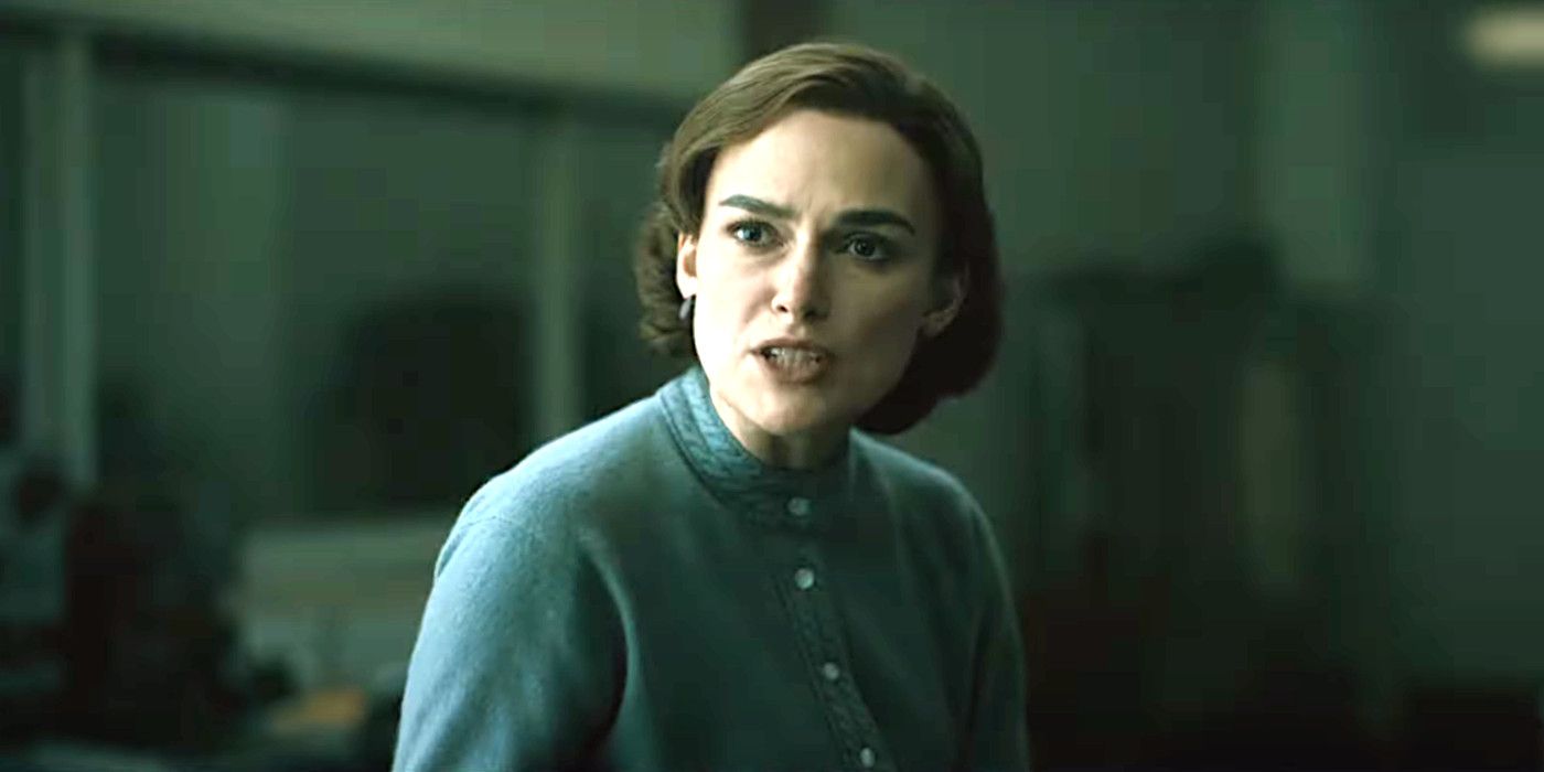 Keira Knightley in Boston Strangler in '60s clothing and hairstyle having an intense conversation in a workplace environment.