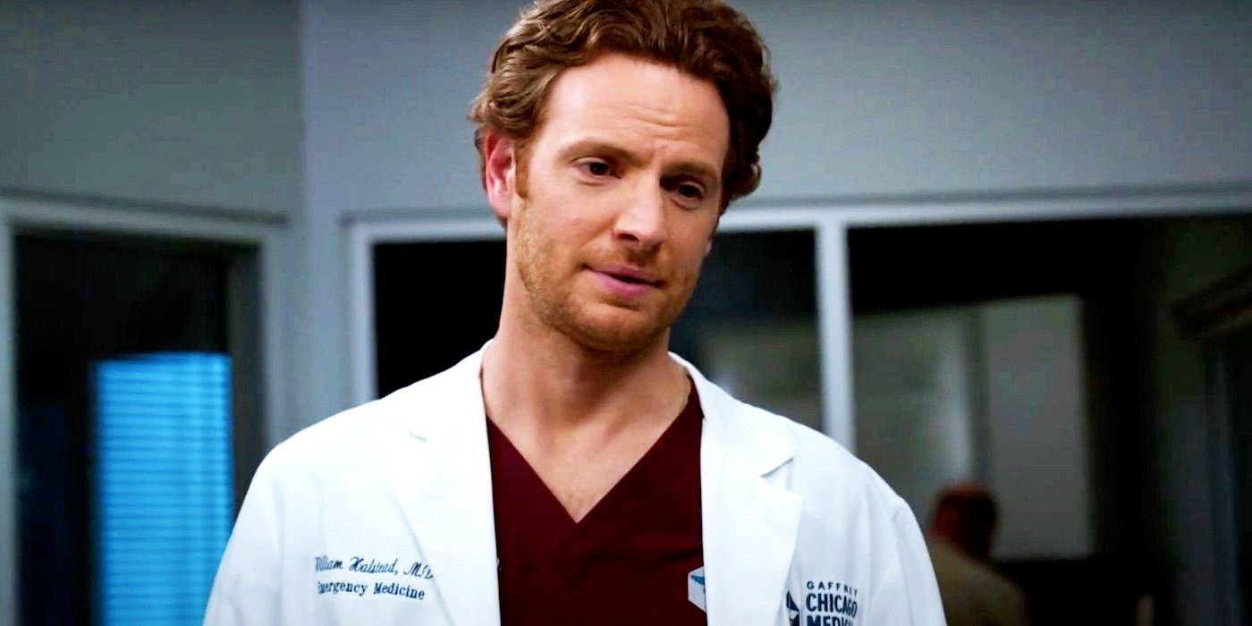William Halstead wearing his white coat and talking at the hospital in Chicago Med