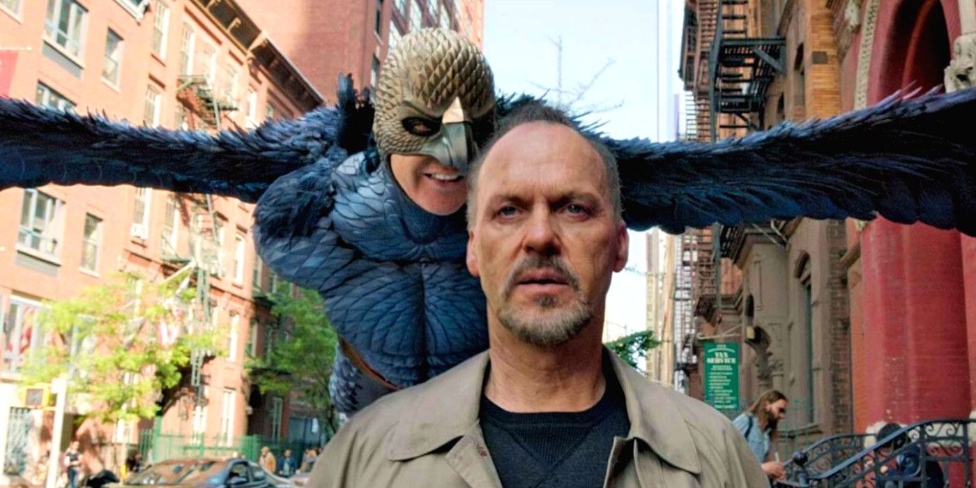 Michael Keaton walking down the street with Birdman flying over his shoulder