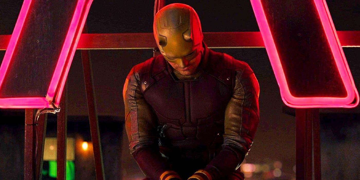 Daredevil sitting in front of a neon sign.