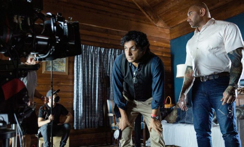 Knock At The Cabin BTS image showing Dave Bautista and M. Night Shyamalan.