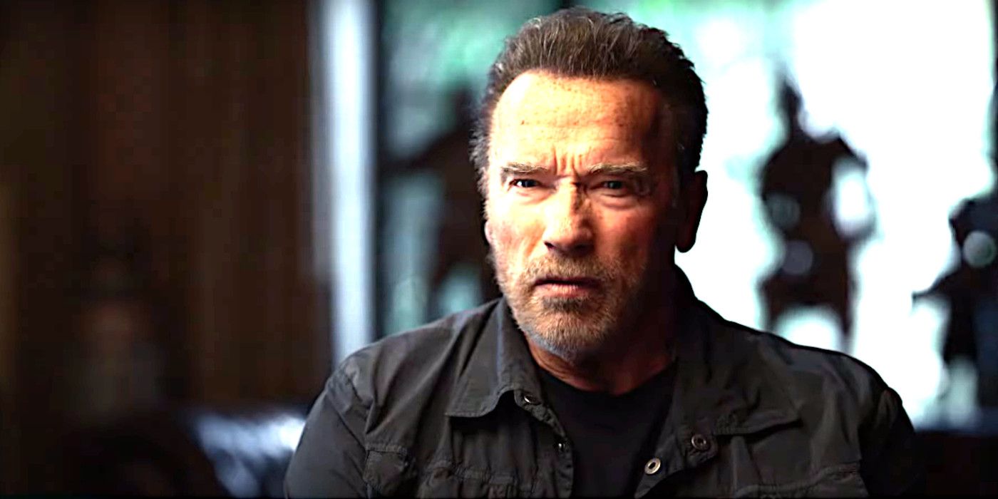Arnold Schwarzenegger in Arnold doing a talking head segment wearing a jacket with a scruffy beard