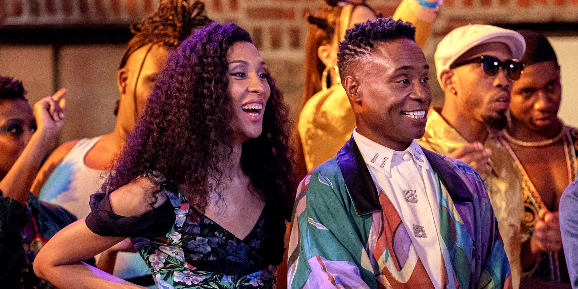 Michaela Jaé Rodriguez and Billy Porter smiling at a party in Pose