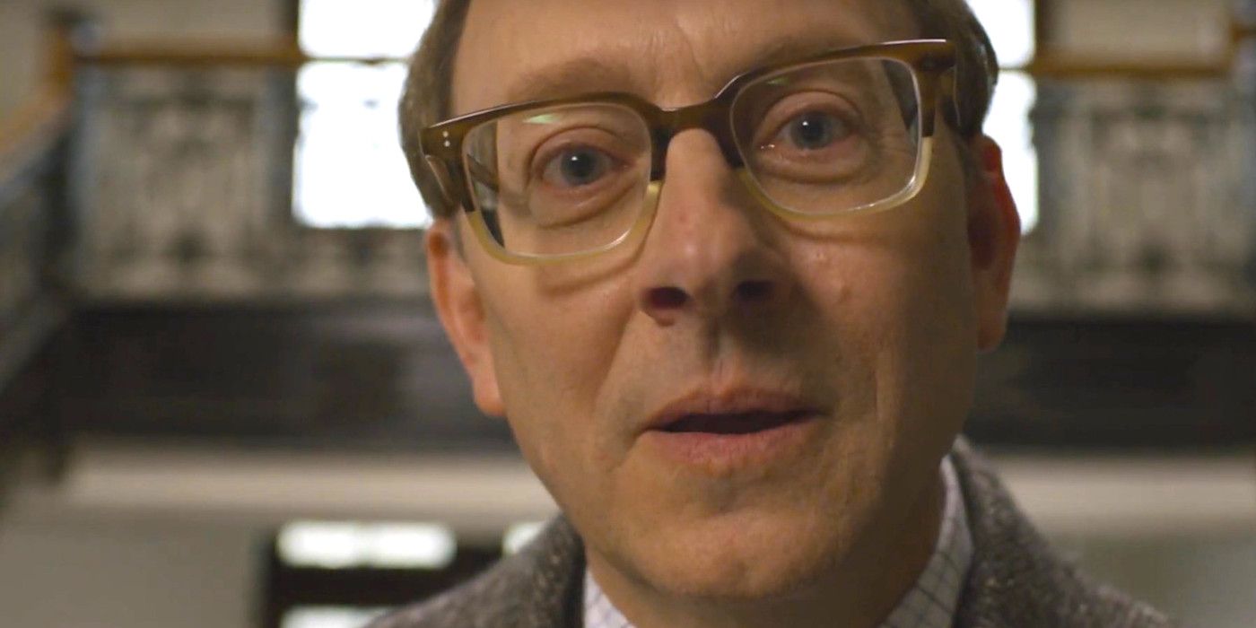 Michael Emerson as Leland in Evil wearing big thick glasses and talking straight into the camera, uncomfortably close to the lens