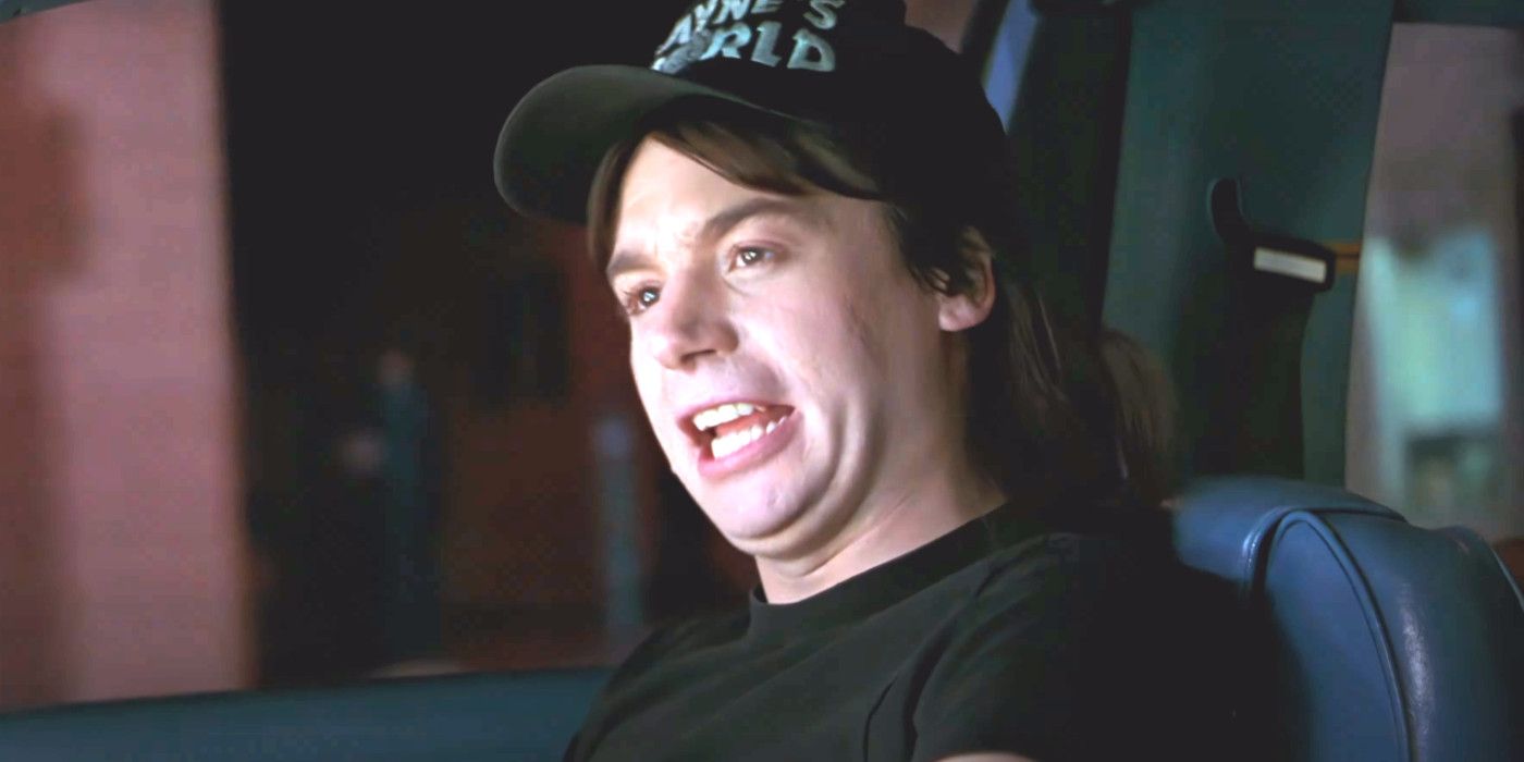 Mike Myers as Wayne in Wayne's World making a funny face while sitting in a car singing along to the Queen song Bohemian Rhapsody
