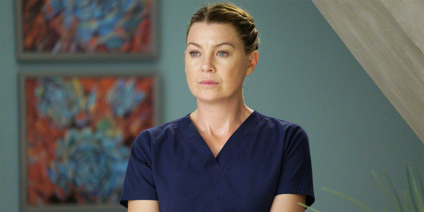 Meredith Grey in Grey's Anatomy standing in hallway wearing scrubs