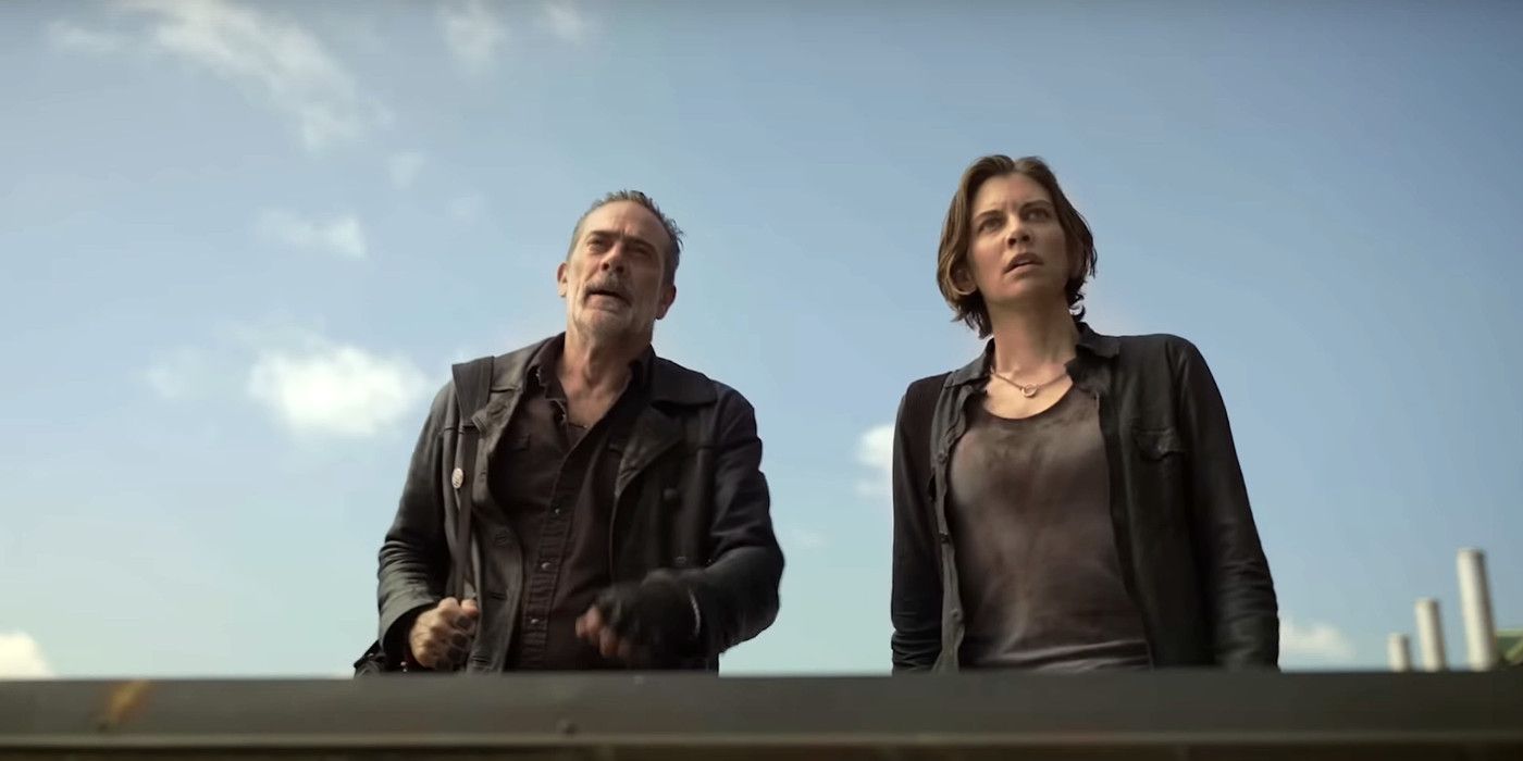 Negan and Maggie in The Walking Dead Dead City looking sweaty and haggard on top of a building, peering down at something