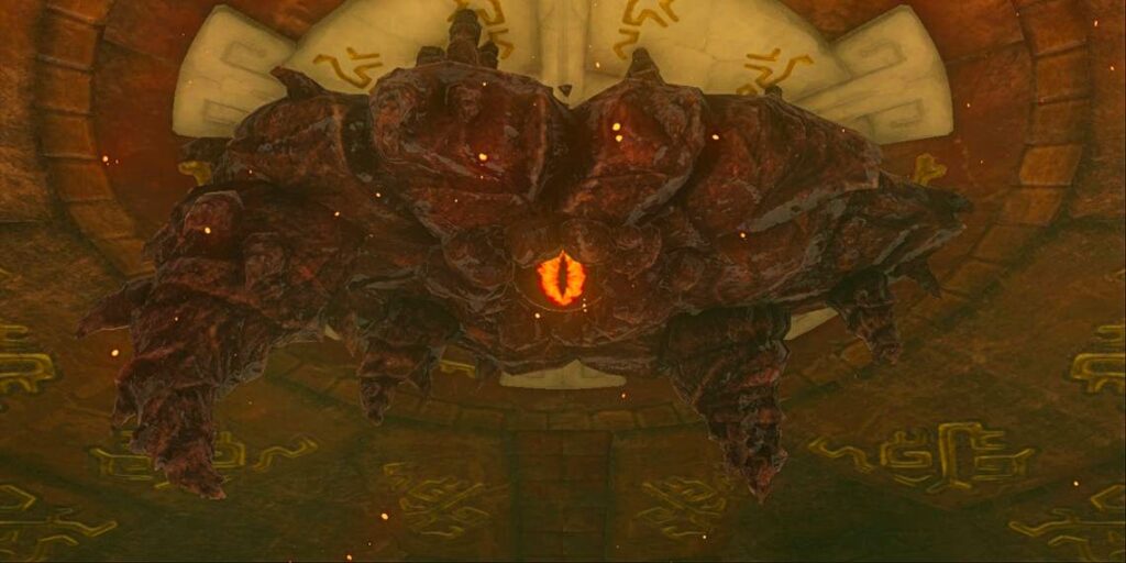 Marbled Gohma, a rocky, insectlike boss, hangs from the ceiling of Tears of the Kingdom's Fire Temple. In the center of its massive form is a glowing orange eye.