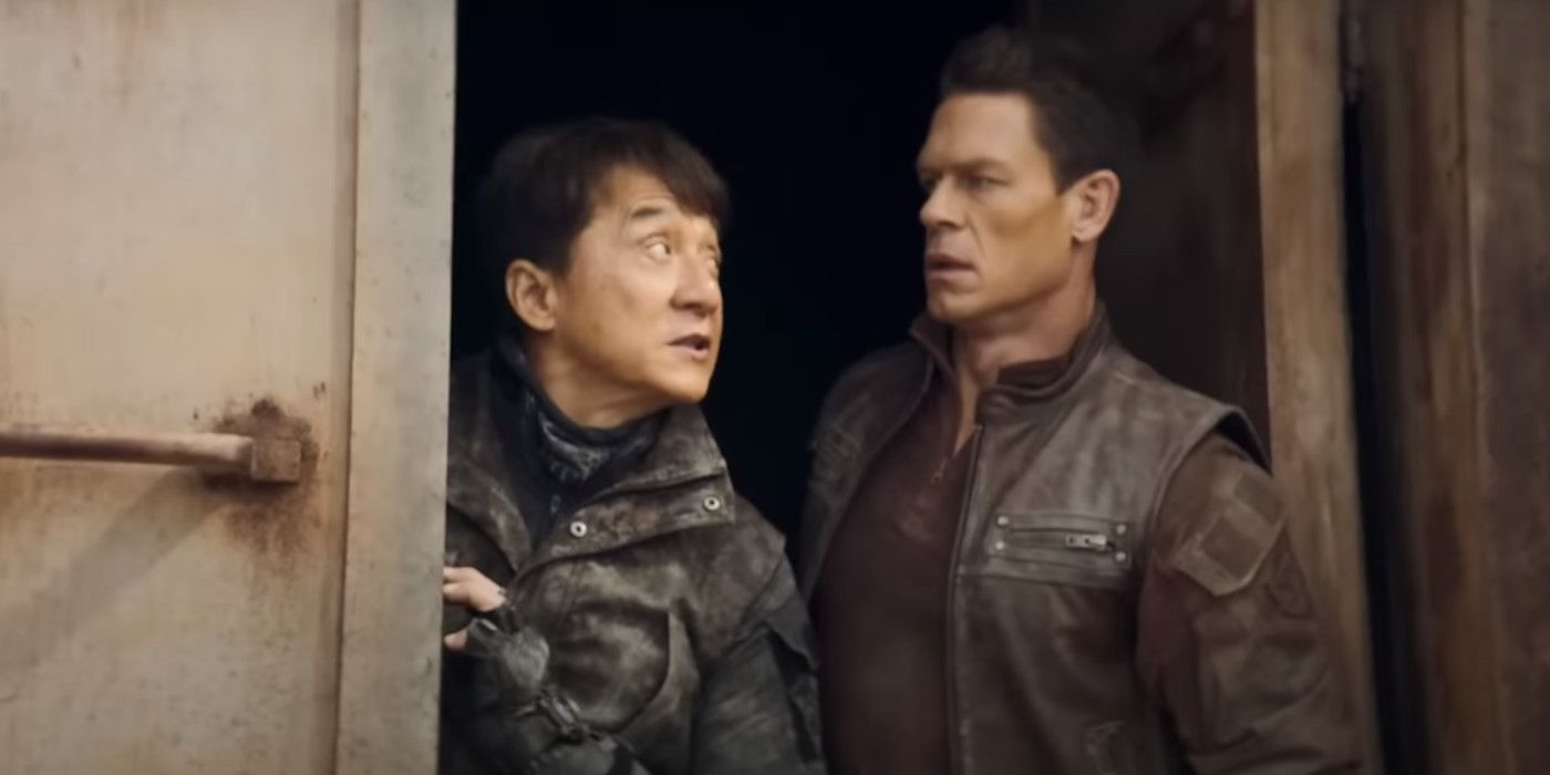 Jackie Chan and John Cena in Hidden Strike dressed in military gear, pausing in a doorway to have a tense looking conversation