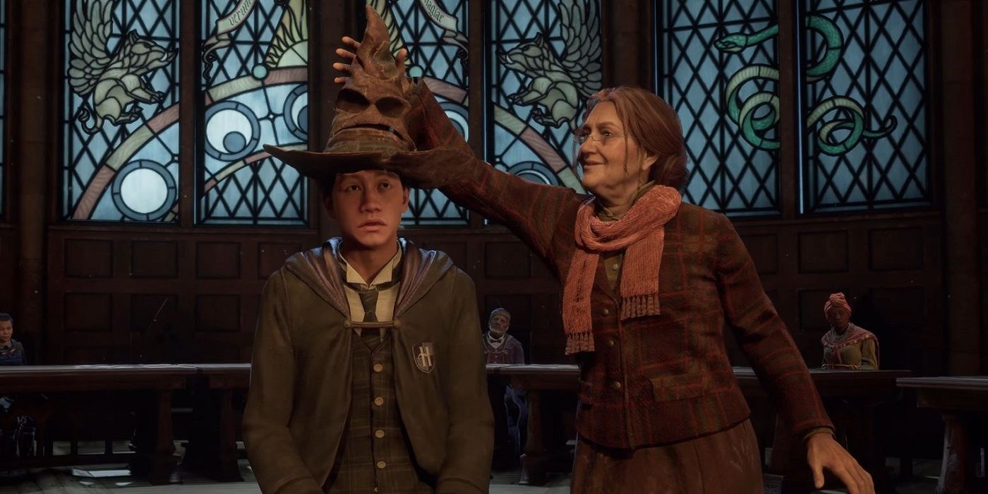 Hogwarts Legacy student having the sorting hat placed on him by a teacher.