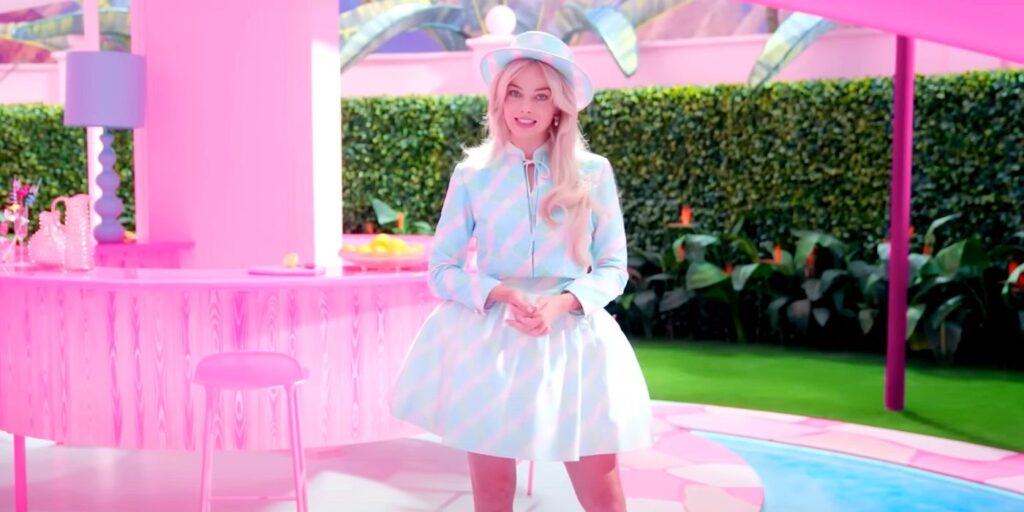 Margot Robbie standing in the Barbie Dreamhouse.