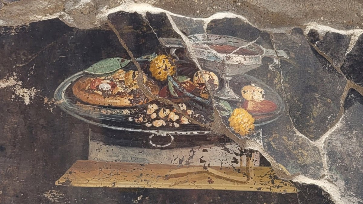 Descubren una pintura de hace 2,000 años que mostraría al antepasado de la pizza