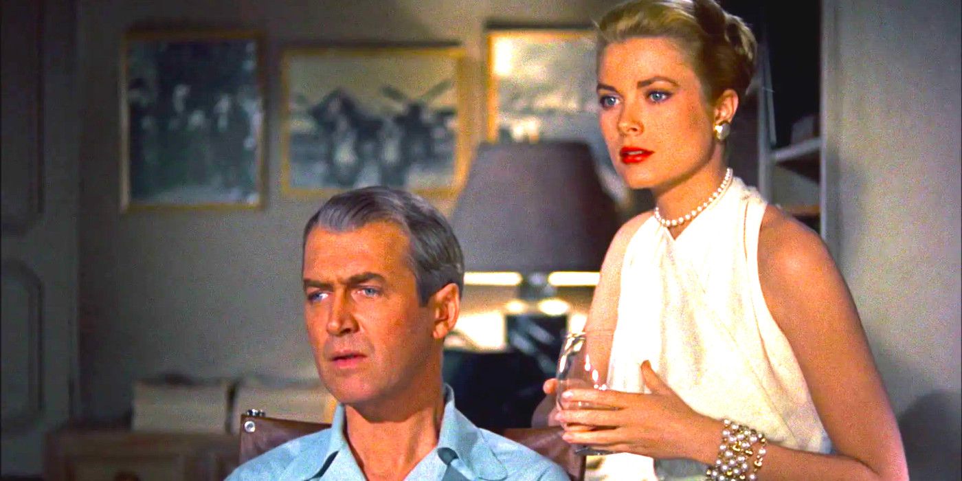 Jimmy Stewart and Grace Kelly in Rear Window standing together gazing with intent interest at something off screen
