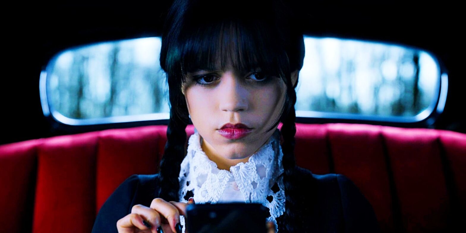 Jenna Ortega as Wednesday looking at phone in car in Wednesday season 1 finale