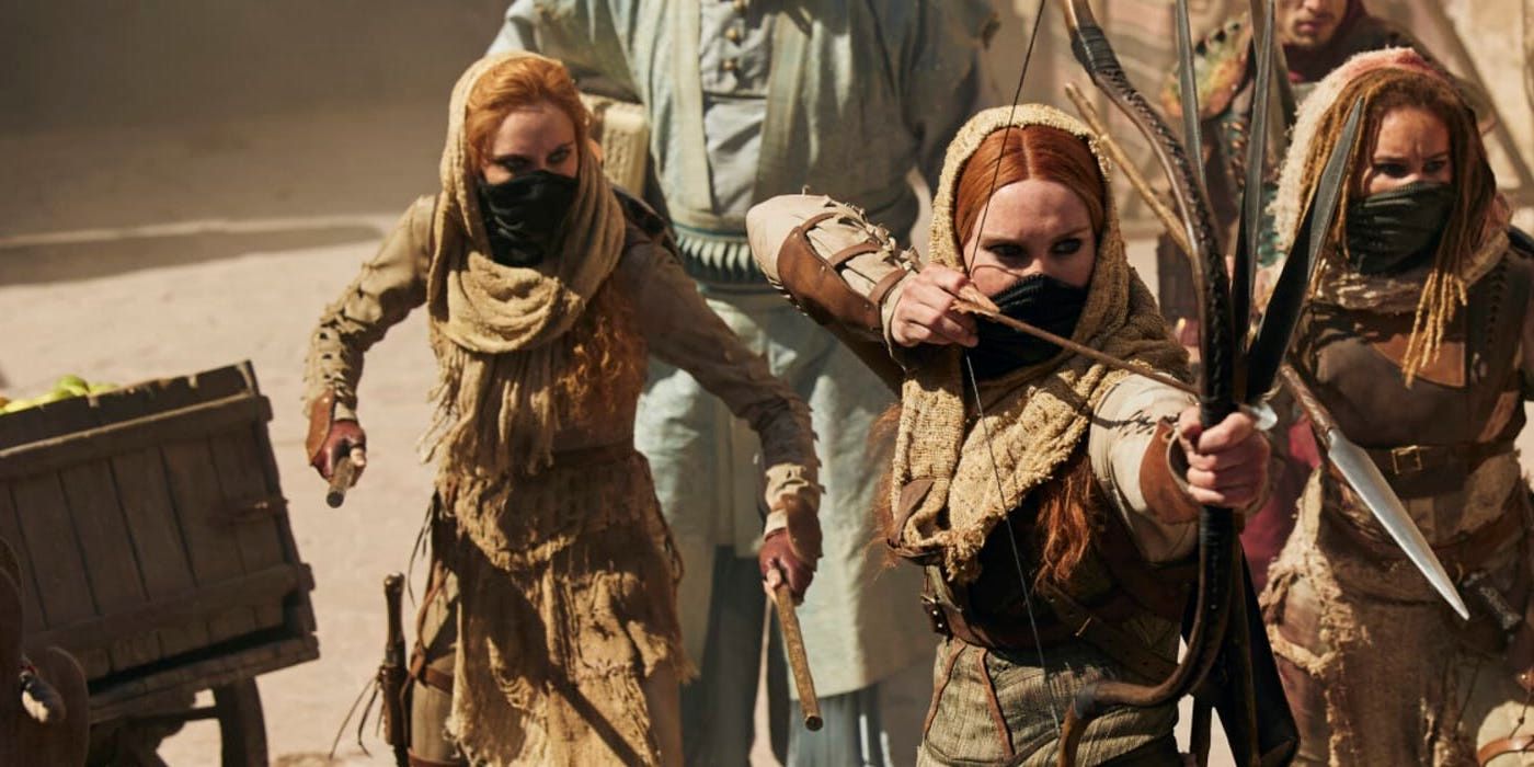 Bain, Chiad, and Aviendha with weapons ready in The Wheel of Time.
