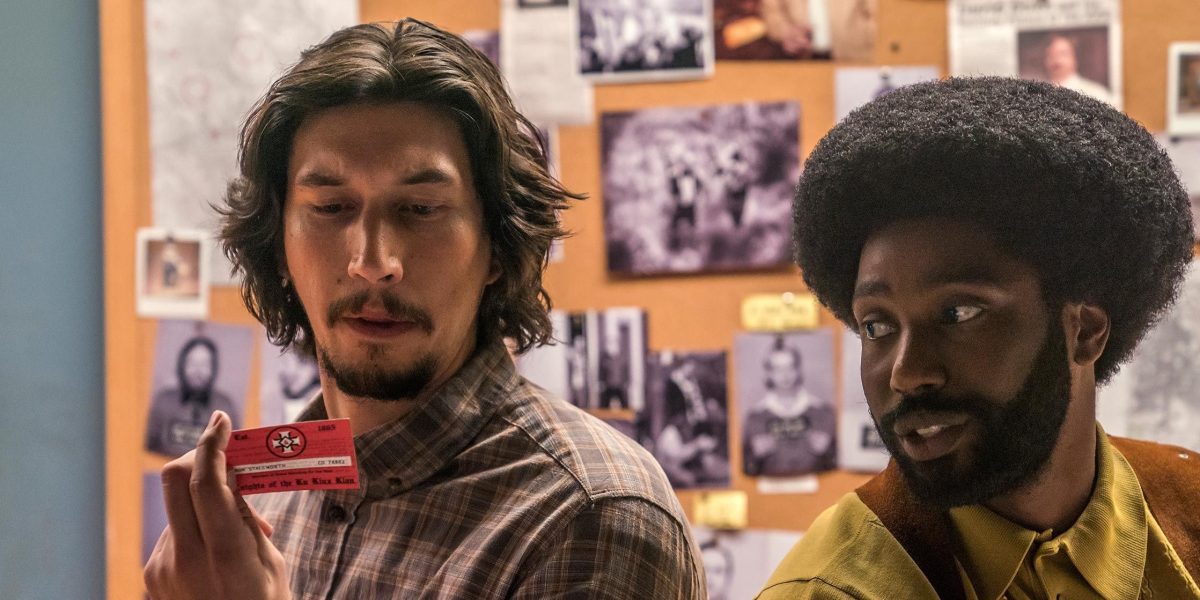 Flip and Ron looking at a card in BlacKkKlansman.