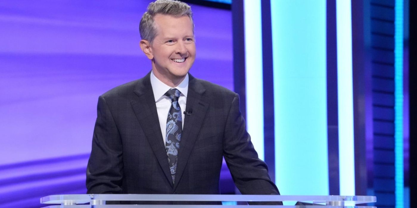 Ken Jennings organizando Jeopardy y sonriendo en concursantes